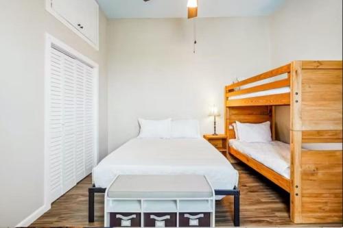 a bedroom with a bed and a bunk bed at Penthouse on Claiborne in New Orleans