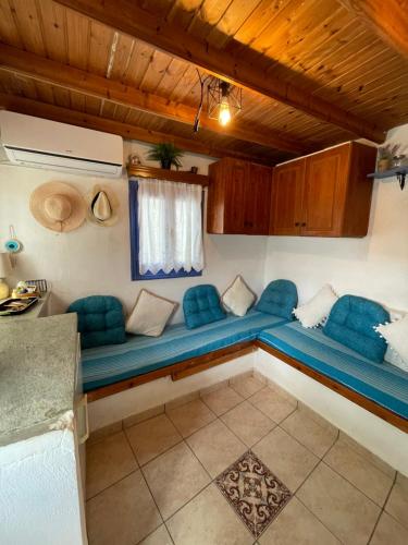 um quarto com um sofá azul num quarto em The absolute AEGIAN view em Pisses