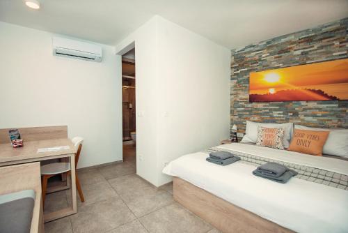 a bedroom with a bed with a brick wall at Old Town Rooms Piran in Piran