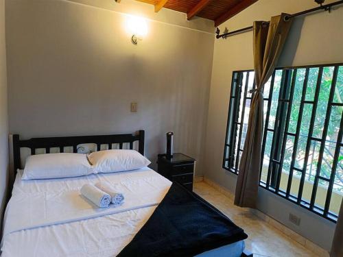 een slaapkamer met een bed met twee handdoeken erop bij !Hermosa Casa en el Mejor lugar de Medellín! in Envigado