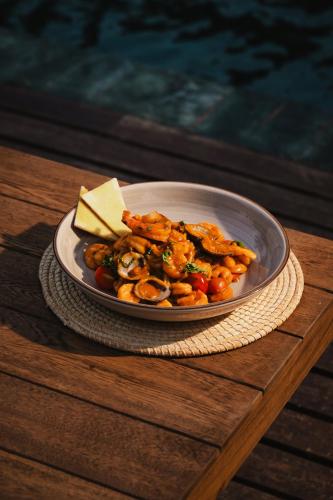 a plate of food with shrimp and cheese on a table at Naio Hotel y Villas By OxoHotel in Palomino