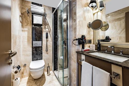 a bathroom with a toilet and a sink at Ramada by Wyndham Istanbul Golden Horn in Istanbul
