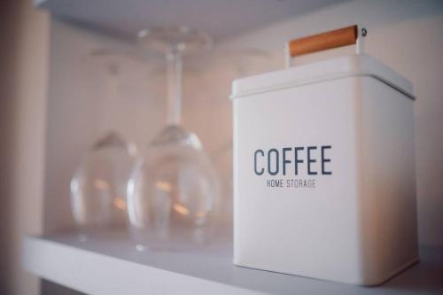 a white coffee box sitting on top of a shelf at Suite 13 Loft mit Terrasse in Teublitz