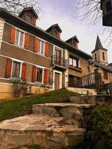 a large house with orange shutters on it at ''Mon Chez Moi'' in Burgalays