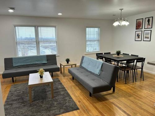 a living room with a couch and a table at Remarkable 3 Room Apt Close to NYC in Jersey City