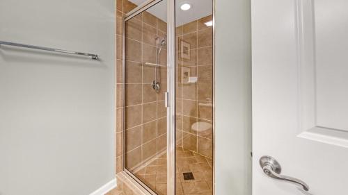 a shower with a glass door in a bathroom at St Lucia 1204 a Luxury Condo with Gulf Views in Destin
