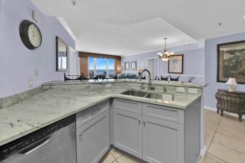 a kitchen with a sink and a counter top at St Maarten 402 a Luxury Beachfront 3 Bedroom Condo Elevator Opens Into Unit in Destin
