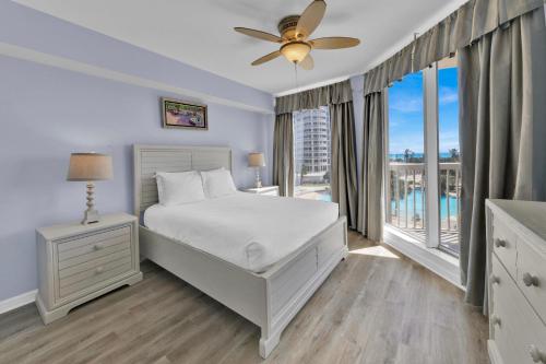 a white bedroom with a bed and a window at St Maarten 402 a Luxury Beachfront 3 Bedroom Condo Elevator Opens Into Unit in Destin