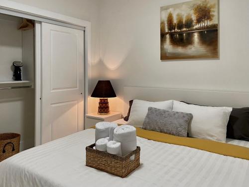 a bedroom with a bed with two baskets of towels at Blissful Stay in Surrey in Surrey
