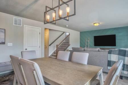 a dining room with a table and chairs and a television at _Entire Home_Game Room_Basement_FirePit_ in Palmer Lake