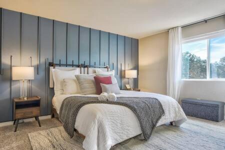a bedroom with a large bed and a large window at _Entire Home_Game Room_Basement_FirePit_ in Palmer Lake