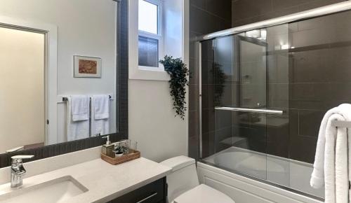 a bathroom with a toilet and a sink and a shower at Blissful Stay in Surrey in Surrey