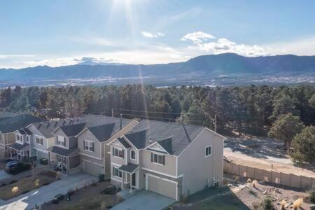an aerial view of a house with mountains in the background at _Entire Home_Game Room_Basement_FirePit_ in Palmer Lake