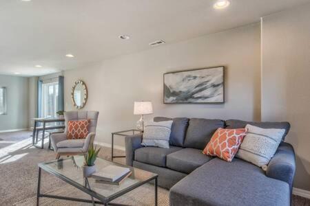 a living room with a couch and a table at _Entire Home_Game Room_Basement_FirePit_ in Palmer Lake