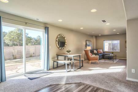 a living room with a couch and a table at _Entire Home_Game Room_Basement_FirePit_ in Palmer Lake