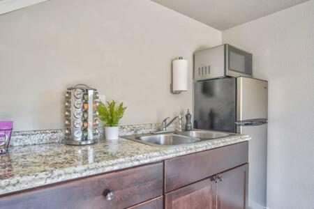 a kitchen with a sink and a refrigerator at _Entire Home_Game Room_Basement_FirePit_ in Palmer Lake