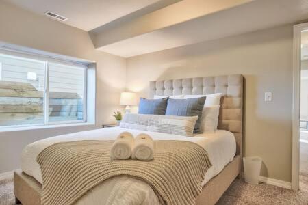 a bedroom with a large bed with two towels on it at _Entire Home_Game Room_Basement_FirePit_ in Palmer Lake