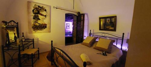 a bedroom with a bed with yellow pillows at chambre love romantique avec spa privée in Calvi