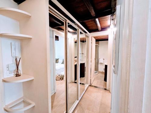 a room with glass doors and a hallway at Piazza di Spagna Heart Of Rome Best LocatioN in Rome