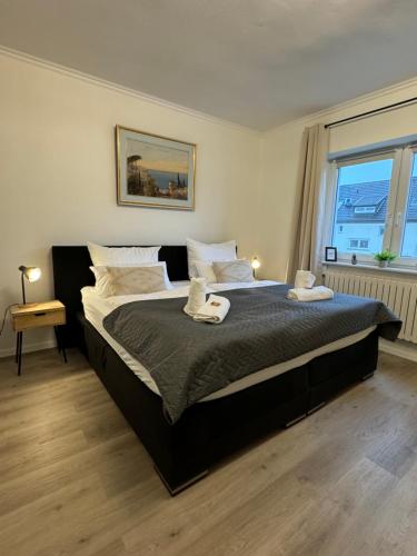 a bedroom with a large bed with two towels on it at Haus mit Garten - Kingbett - WIFI - Parkplatz in Essen