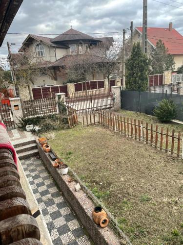 a yard with a fence and a house at House in Budapest