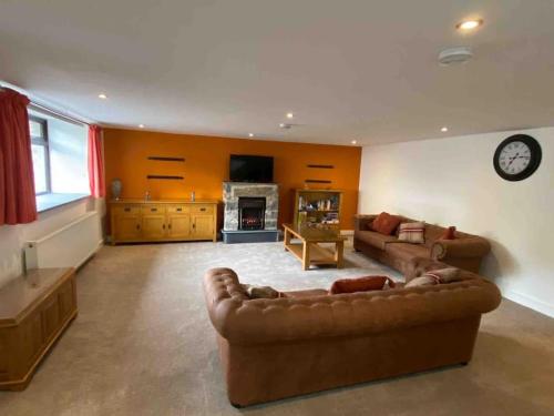 a large living room with a couch and a fireplace at Langway in Gatebeck