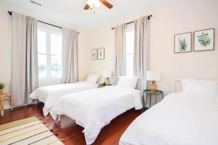 a white room with three beds with white sheets at The Venice Oasis - 4BR-3BA 16 Guests in Atlantic City