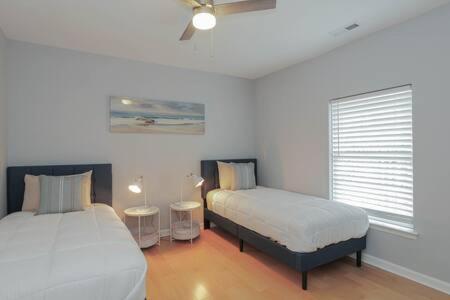 a bedroom with two beds and a window at Bartram Dream House II - Bartram Beach Retreat in Atlantic City