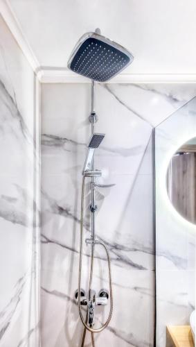 a shower with a ceiling fan in a bathroom at Arachova's Experience M3 in Arachova