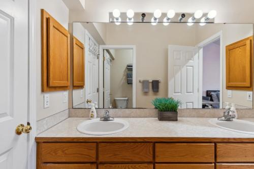 a bathroom with two sinks and a large mirror at 2BR Seattle Oasis - A Short Stroll to Light Rail in Seattle
