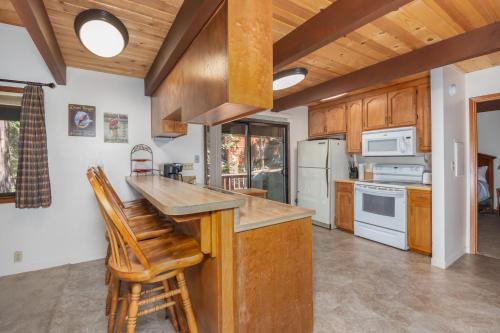 a kitchen with wooden cabinets and white appliances at Kevkos Cabin in Arnold