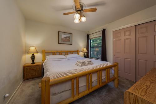a bedroom with a bed and a ceiling fan at Dragonfly Lodge in Arnold