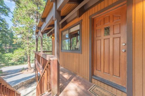 a wooden front door of a house with a porch at Kevkos Cabin in Arnold
