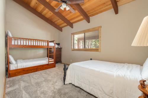 a bedroom with two bunk beds and a window at Peaceful Pinecone in Dorrington