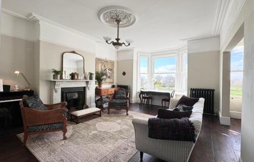 a living room filled with furniture and a fireplace at Stylish elegant two bedroom apartment overlooking Southsea Common and the Solent in Portsmouth