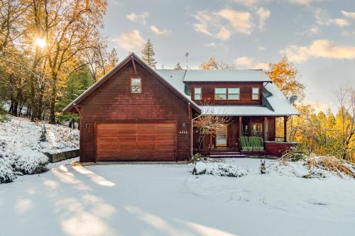 a house with a wooden garage in the snow at Murph Lodge in Murphys