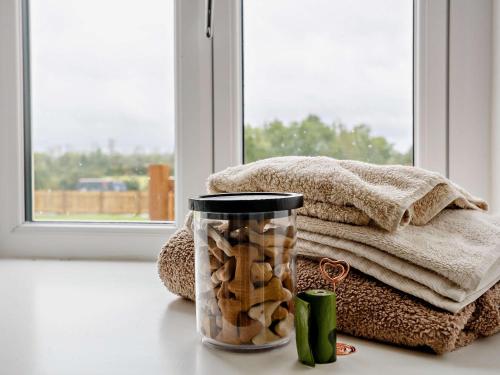 a jar of nuts on a table next to a window at 2 Bed in Wintersett 93235 