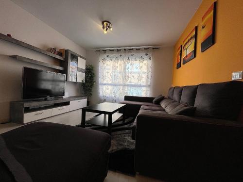 a living room with a couch and a television at Casa La Laguna in La Laguna