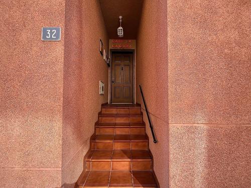 a hallway with a door and stairs in a building at Casa La Laguna in La Laguna