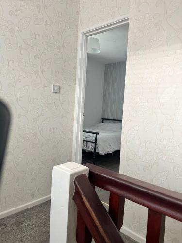 a hallway with a mirror and a bed in a room at Macs Belfast Single bedroom in Belfast