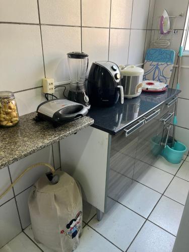 a kitchen with a counter with a blender on it at Quarto acolhedor em apto com ótima localização. in São Luís