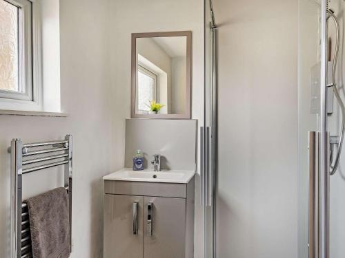 a bathroom with a sink and a mirror at 2 Bed in Keswick 87092 in Keswick