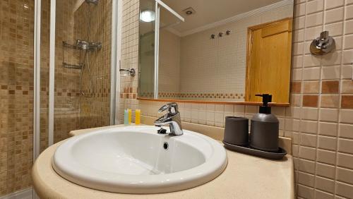 a bathroom with a sink and a mirror at TERRAMAR sweet home in Villajoyosa
