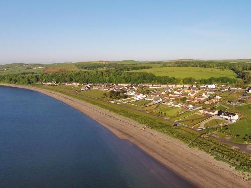 an aerial view of a town next to the beach at Tigh Na Mara Hotel in Sandhead