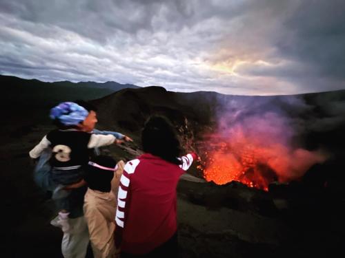 a group of people standing on top of a fire at Tanna Evergreen Resort & Tours in Tanna Island