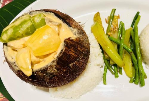 a plate of food with rice and vegetables on it at Tanna Evergreen Resort & Tours in Tanna Island