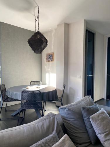 a living room with a table and a couch at Loft al mare Porto San Giorgio in Porto San Giorgio