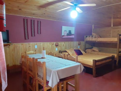 a dining room with a table and two bunk beds at Las Moras in Reyes