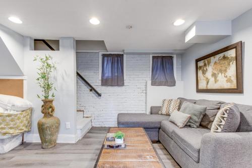 a living room with a couch and a table at 1 Mi to Coors Field Cozy Denver Studio with Patio! in Denver