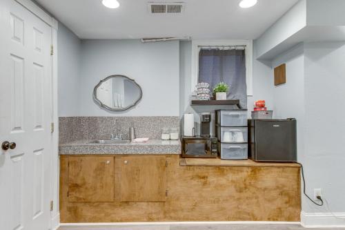 a kitchen with a sink and a counter with a microwave at 1 Mi to Coors Field Cozy Denver Studio with Patio! in Denver